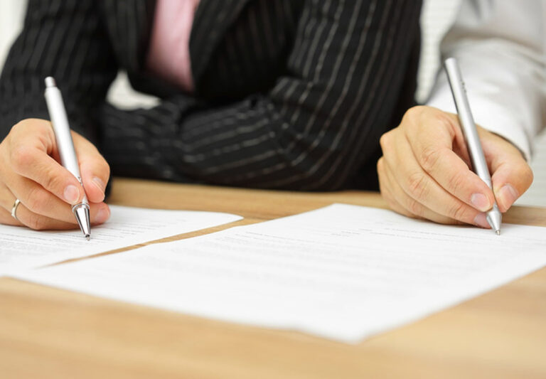 Couple signing divorce documents