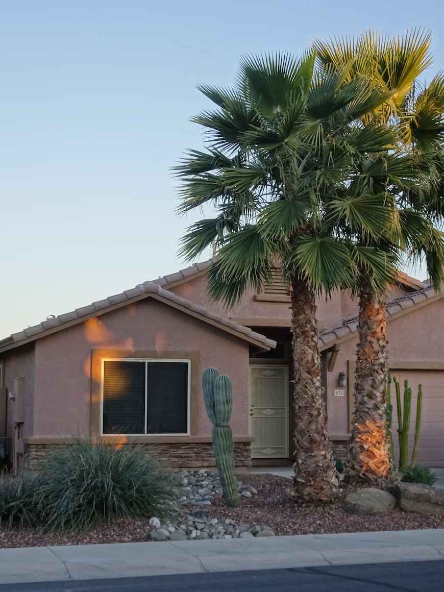 image of a house with palm trees and cacti in the front yard