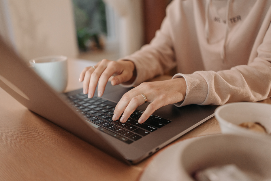 This is an image of a woman typing on her laptop.