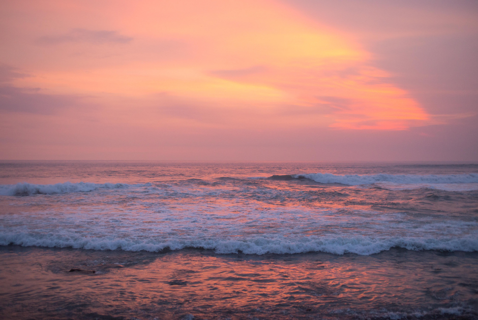 This is a serene image of a beach at sunset.