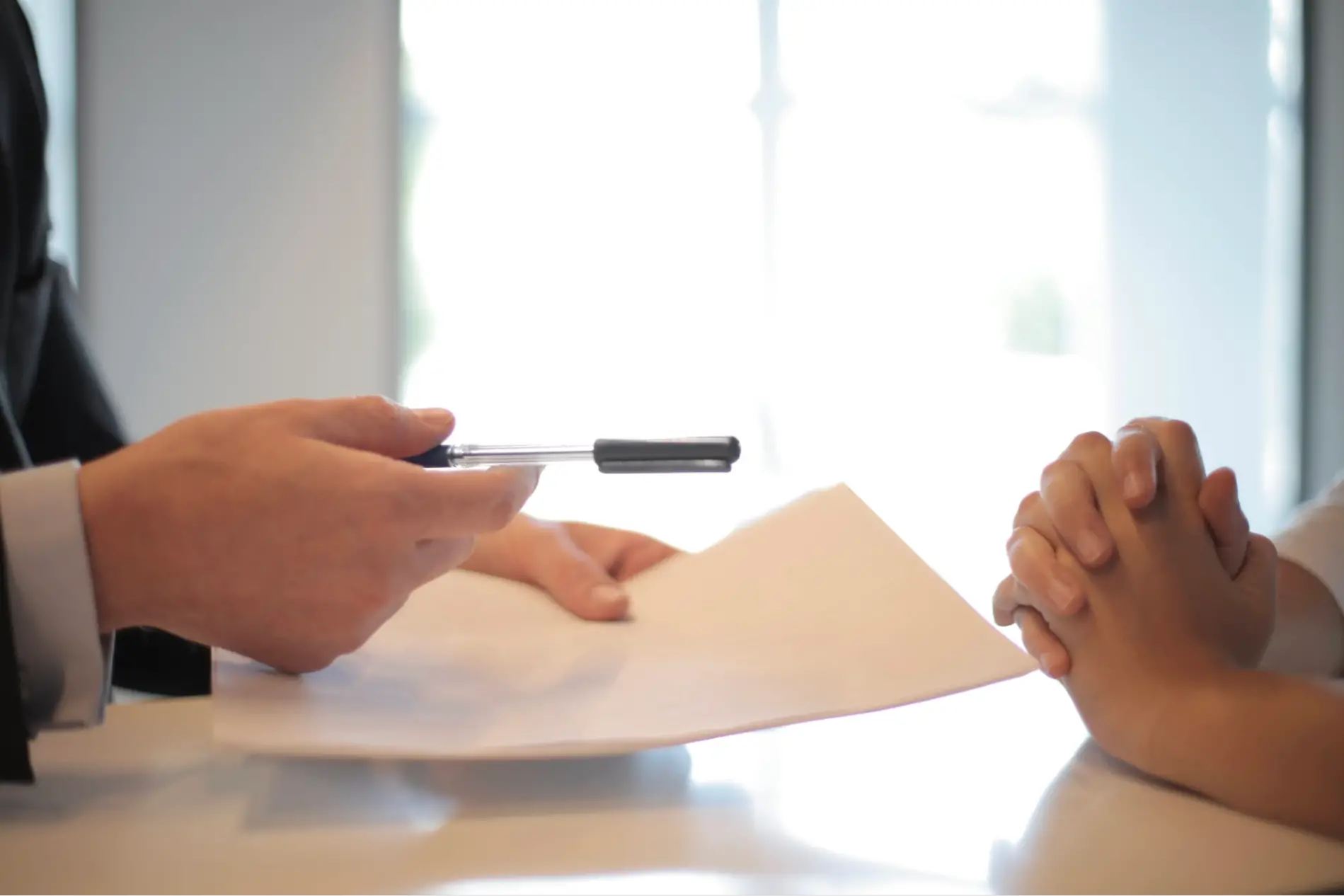 This is an image of a person asking another person to sign legal documents.