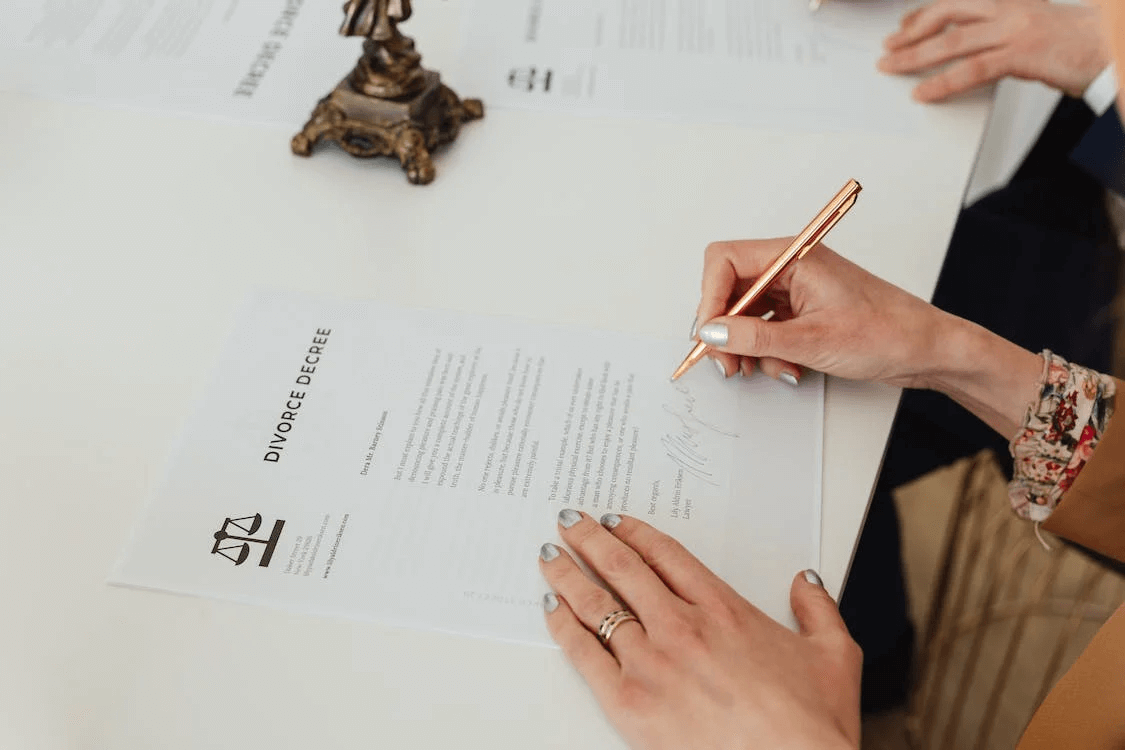Spouses sign their final divorce decree