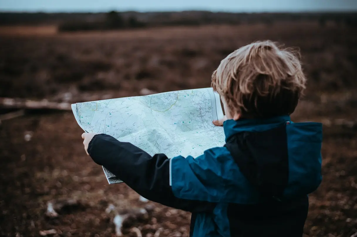 This is an image of a child holding a map.