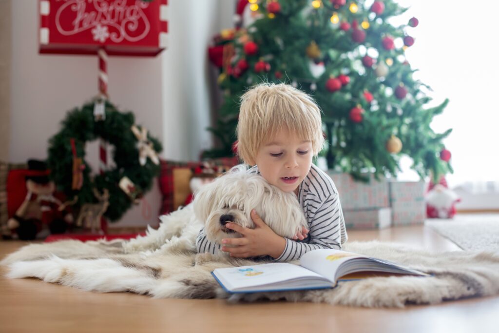 beautiful,toddler,child,,reading,book,with,pet,dog,in,front