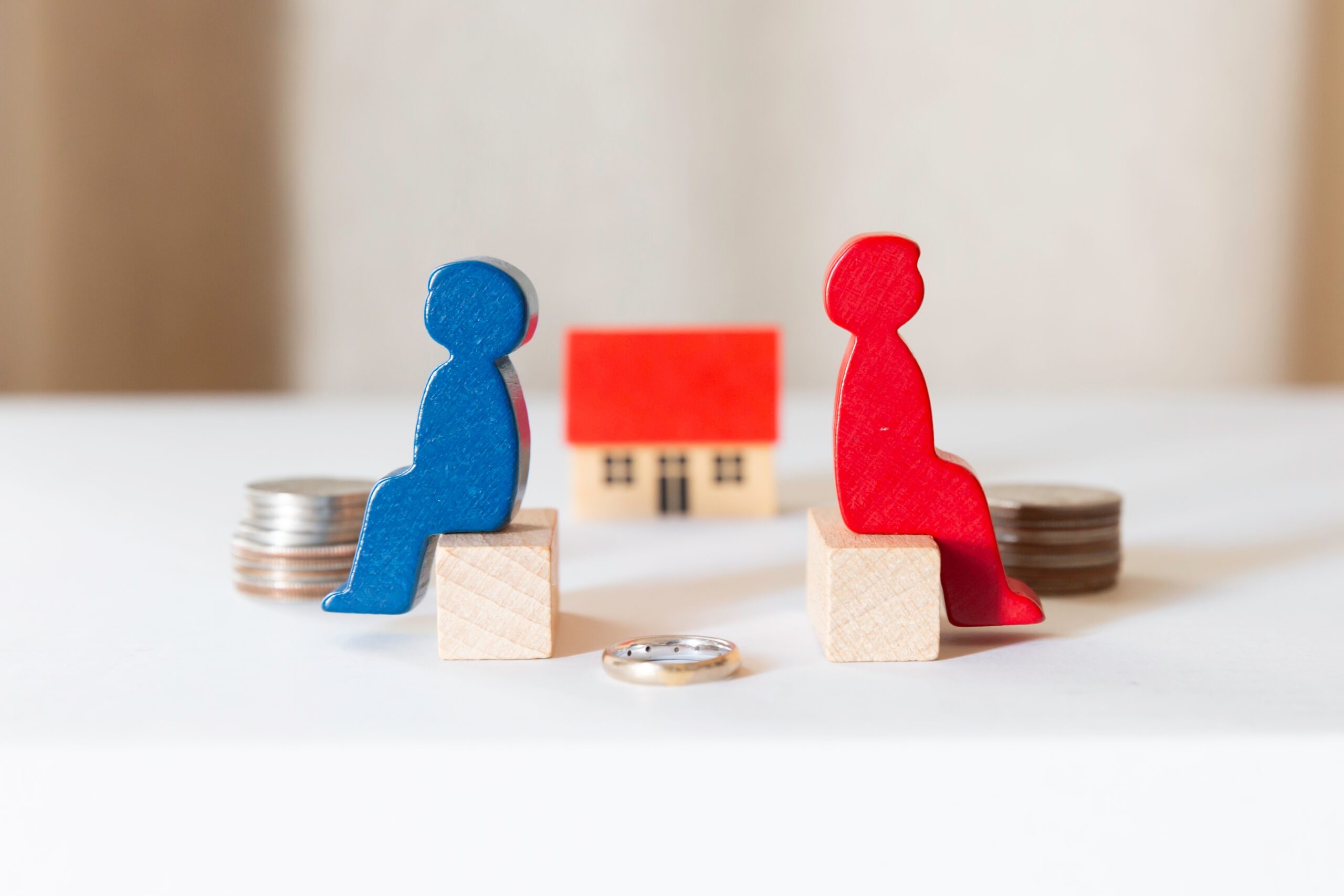 a couple of small wooden figurines sitting on small wooden blocks, divorce